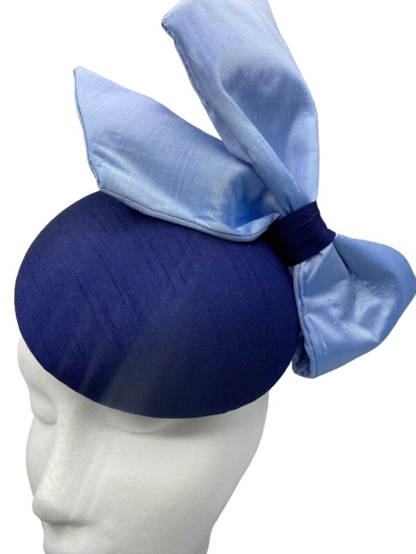 Stunning navy raw silk base headpiece with a beautiful raw silk steel blue side bow to finish.